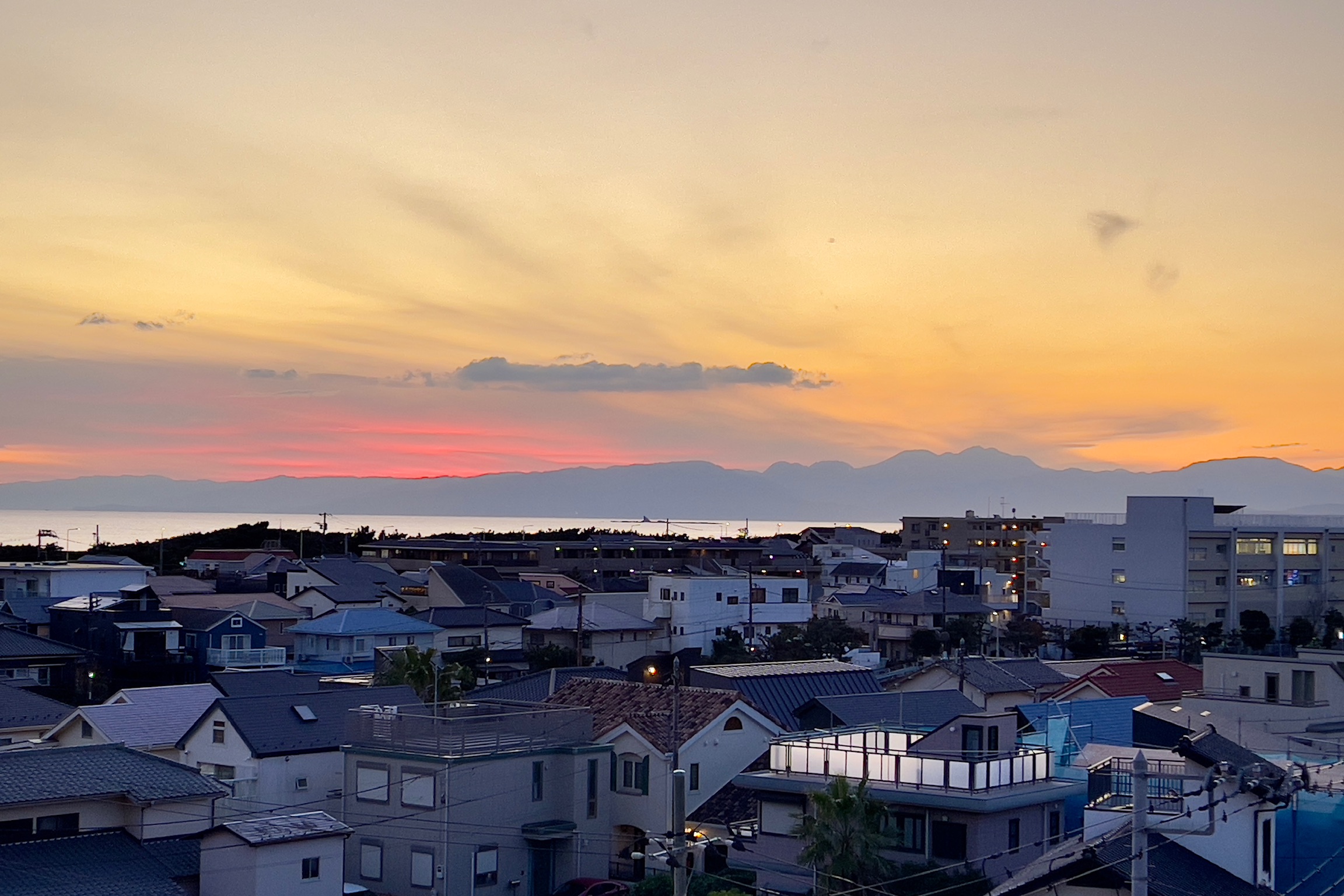 住まいから望む、夕暮れの海と富士山