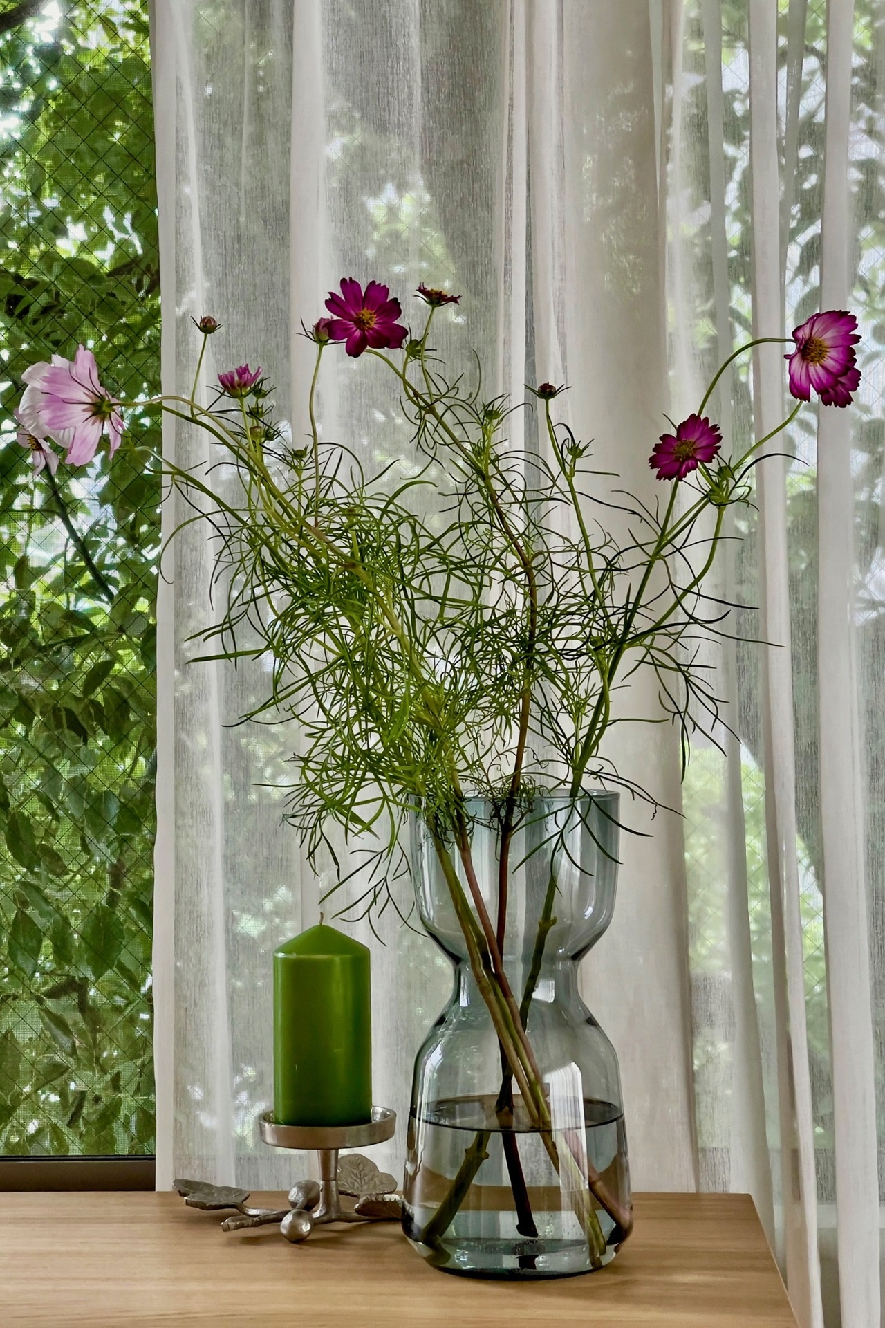 やわらかな光を受ける花枝とガラスの花器